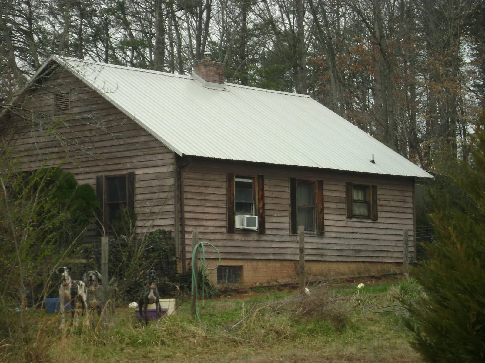 White metal roof on an old wood sided farmhouse, from a Asphalt Shingle Roof Repair job in Wakonda